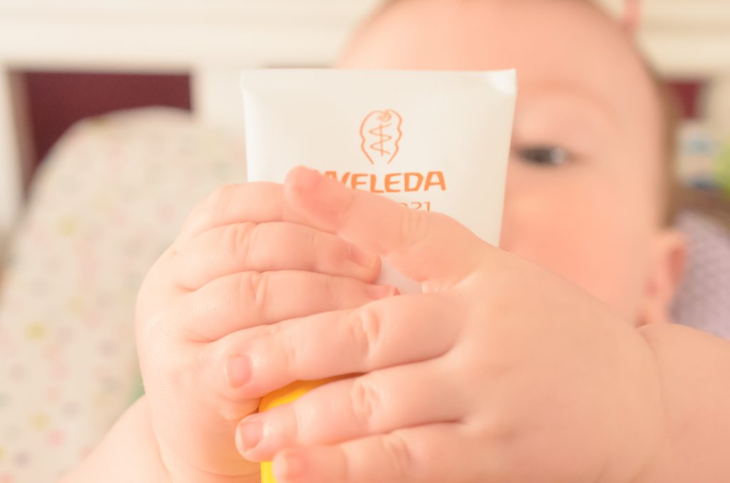 Jonah holding Weleda nappy cream