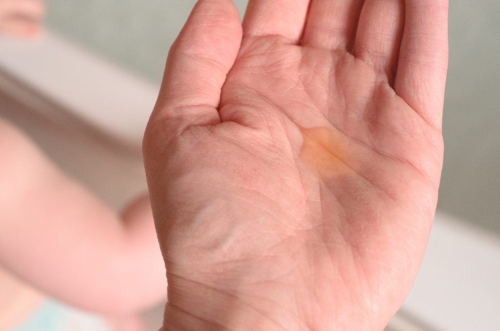 Mia & Dom Organic Baby Bath Oil in the hand