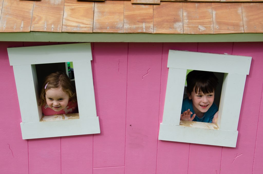 Jonah and Cara looking through windows