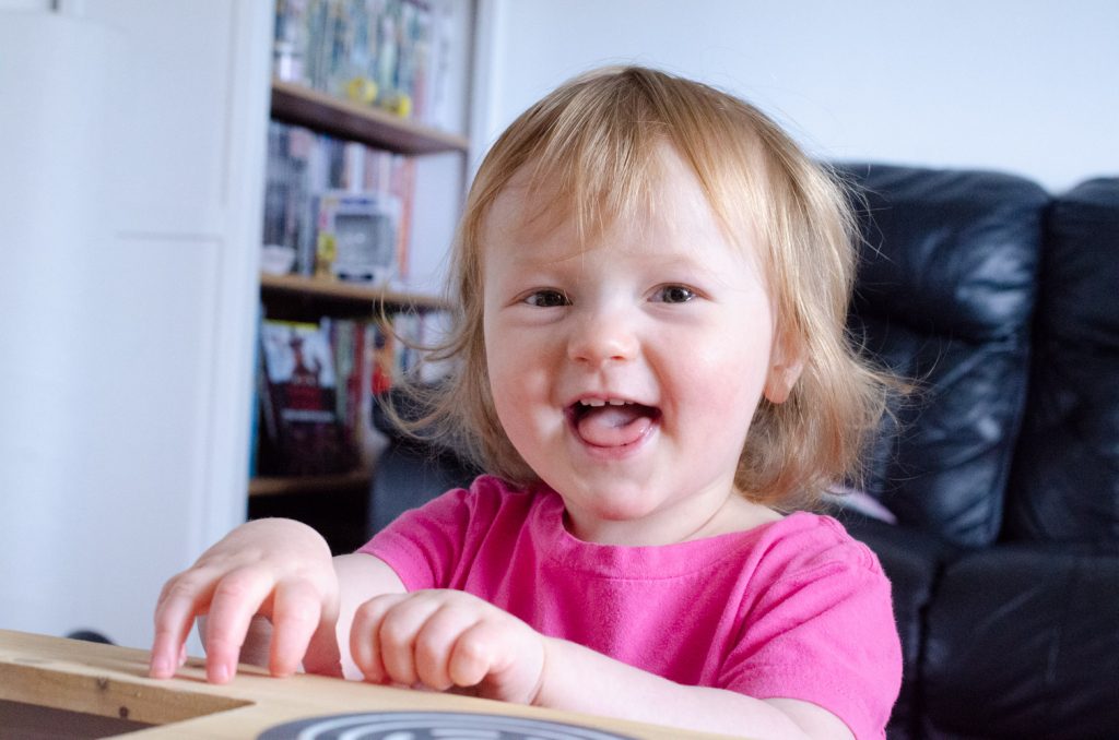 Lydia playing and smiling