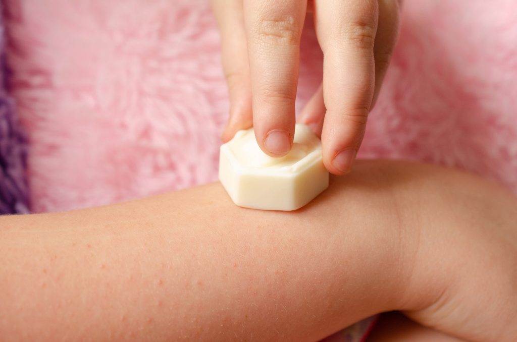 Using the solid bar on her skin