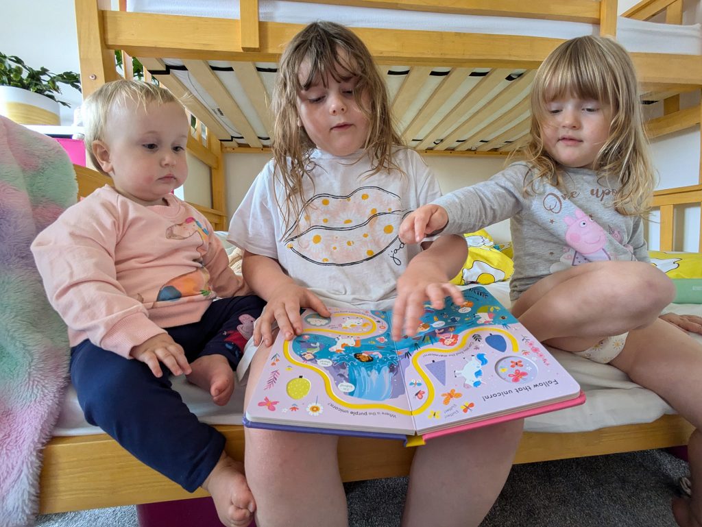 Lydia reading with her sisters