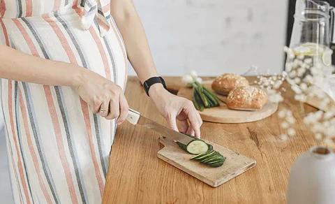 Pregnant woman prepares food