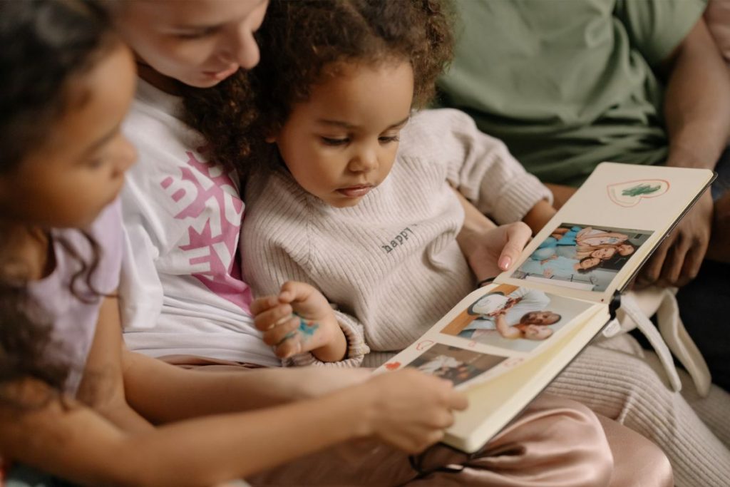 Mom and toddler looking through the baby book