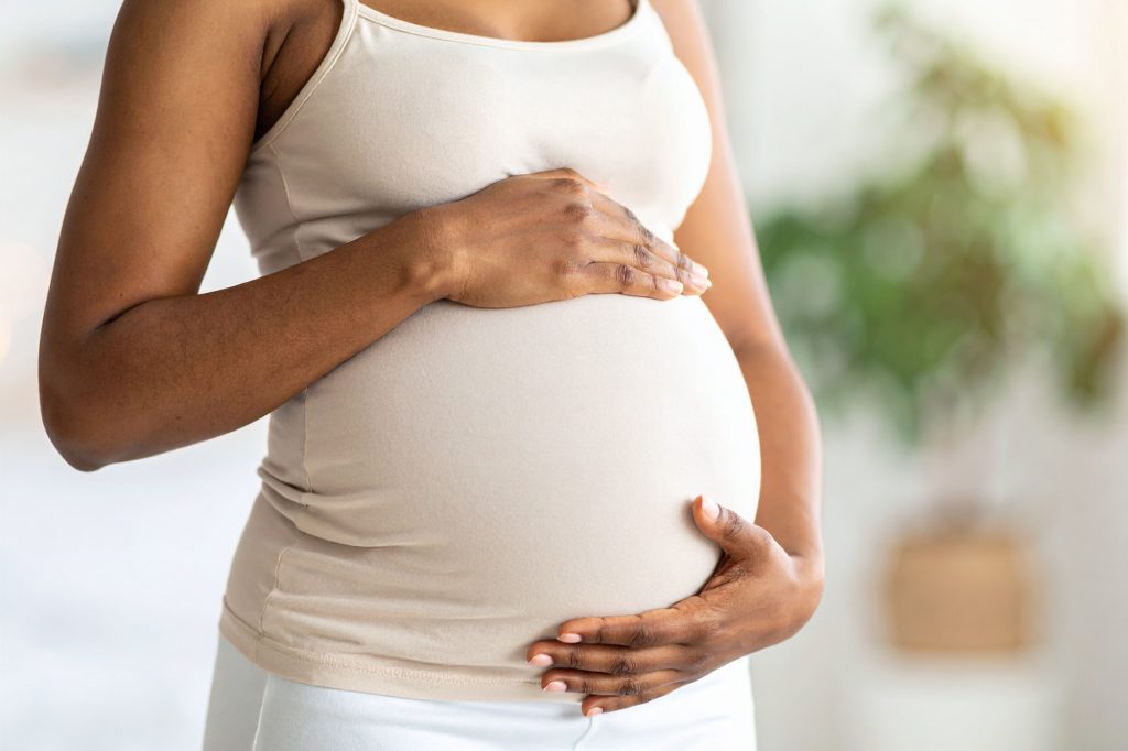 Pregnant woman caring for her bump